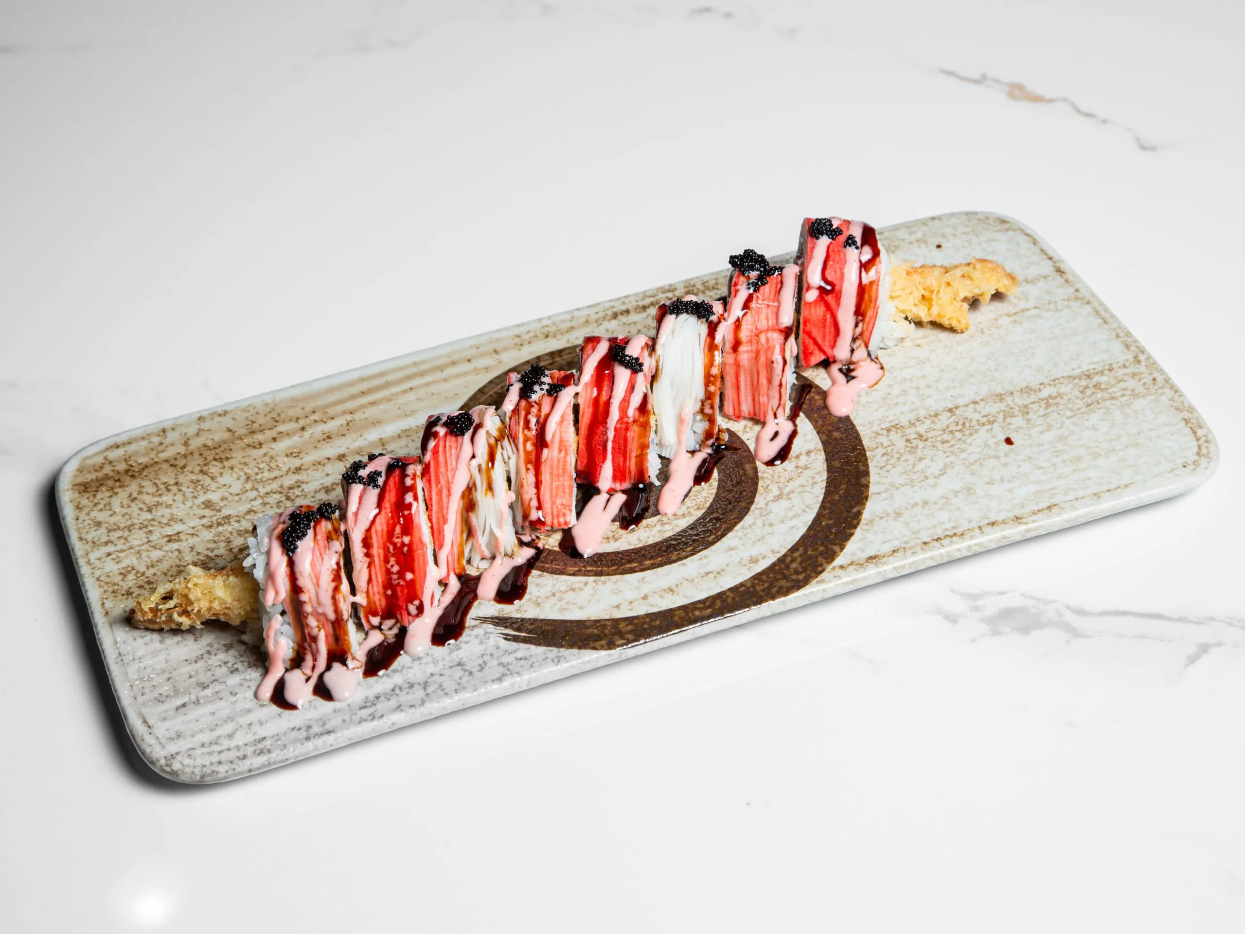 Sushi roll with eel, crab and spicy sauce at Kuchi, a Buffet Restaurant in Tampa