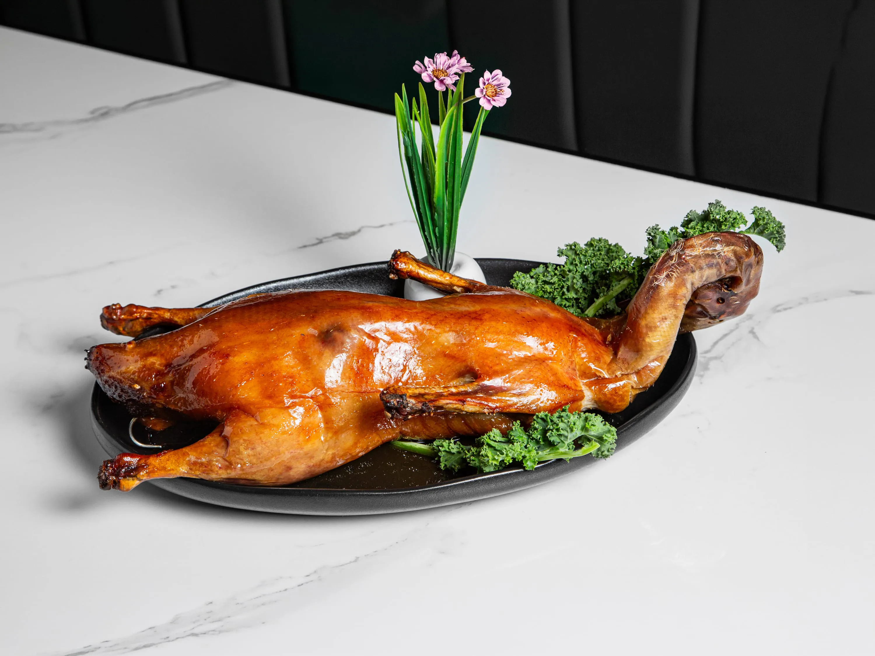 Crispy whole roast duck with savory sauce at Kuchi, a Buffet Restaurant in Tampa